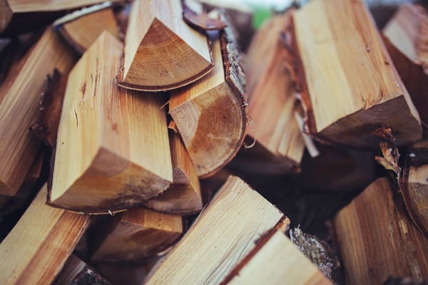 Freshly split firewood logs with exposed wood grain and bark